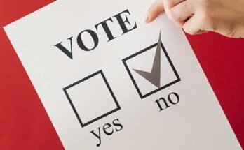 A person casting a "No" ballot